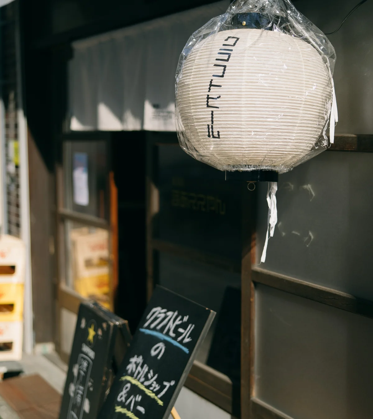 麦酒店まぁええやんの店先。「クラフトビール」のちょうちんと黒板