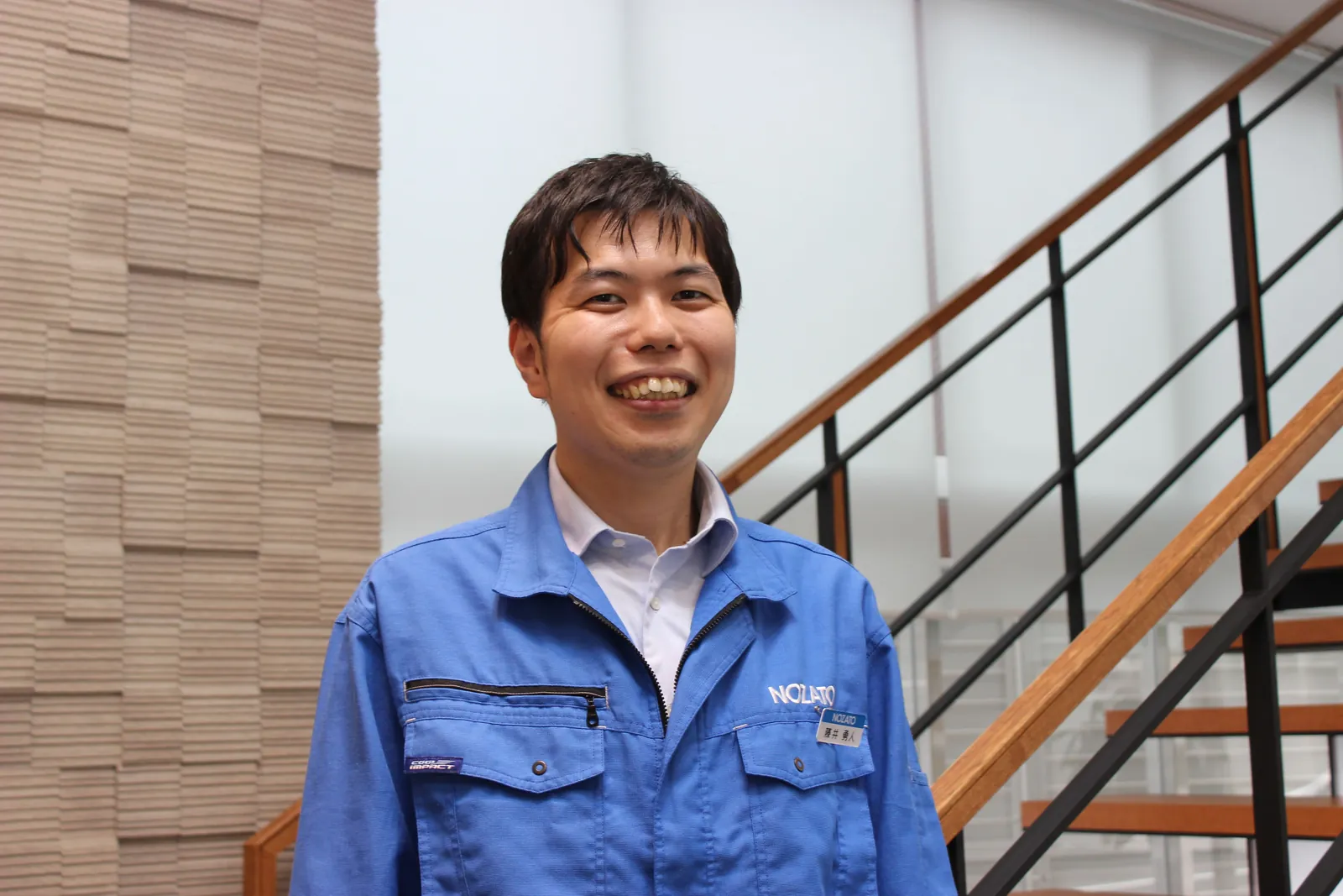 階段の前で笑う藤井さん